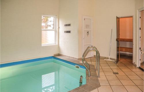 a bathroom with a swimming pool in a room at Holiday Home Mosevråvej Oksbøl Ii in Mosevrå