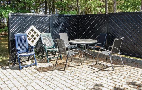 a group of chairs and a table on a patio at Holiday Home Mosevråvej Oksbøl Ii in Mosevrå