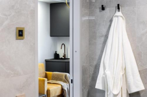 a bathroom with a shower with a towel hanging on the wall at F-Apartments - City Center with Fireplace, Contactless in Tartu
