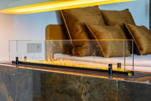 a fireplace in a living room with a couch at F-Apartments - City Center with Fireplace, Contactless in Tartu