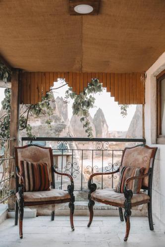 a bench sitting on a porch with a window at Turan Cappadocia Cave in Goreme