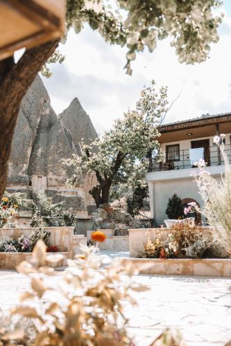 a view of a garden with a mountain in the background at Turan Cappadocia Cave in Goreme