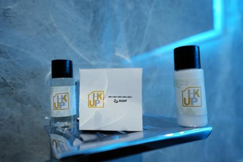 two bottles of liquids sitting next to a box at Hotel JK palace in Allahābād