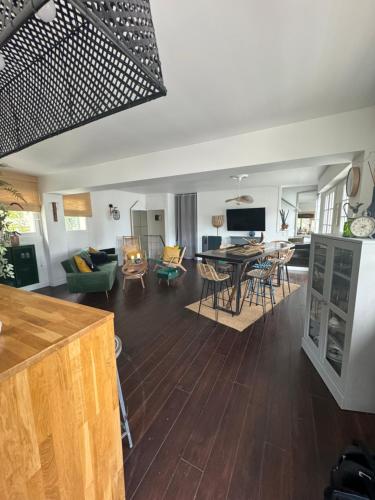 a kitchen and living room with a table and chairs at VILLA LA PLAGE in Trouville-sur-Mer