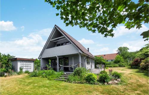 a gray house with a gambrel roof on a yard at 4 Bedroom Cozy Home In Torekov in Torekov