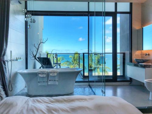 a bathroom with a tub and a large window at 漫漫日出海景民宿 證號2094 in Hualien City