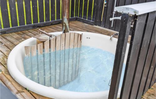 a bath tub filled with water with a wooden fence at Holiday Home Sydals With Hot Tub Vii in Sarup