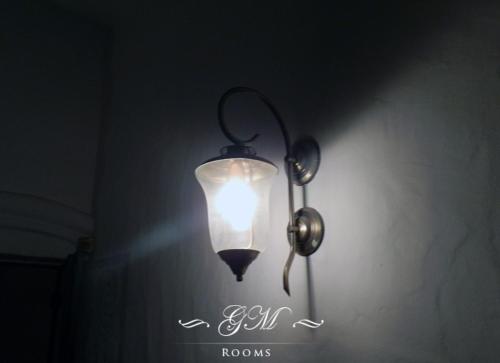 a light hanging from a wall in a room at GM Rooms Boutique Hotel in La Rioja