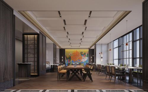 a dining room with a table and chairs at UrCove by HYATT Shantou Zhugang New Town in Shantou