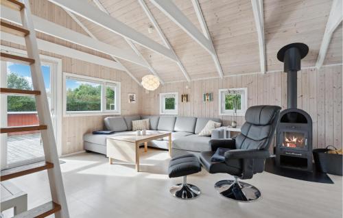 a living room with a couch and a fireplace at Lovely Home In Hemmet With Kitchen in Hemmet