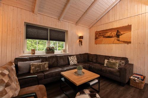 a living room with a couch and a table at Kustelberg Lodges in Medebach