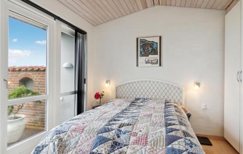 a bedroom with a bed and a large window at 2 Bedroom Cozy Home In Nyborg in Nyborg
