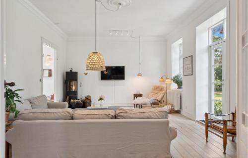 a white living room with a couch and a table at 3 Bedroom Pet Friendly Home In Søby Ærø in Søby