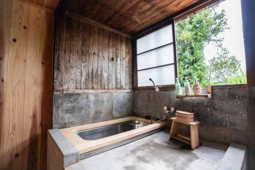 a kitchen with a sink and a large window at MAYUDAMAHOUSE in Higashiagatsuma
