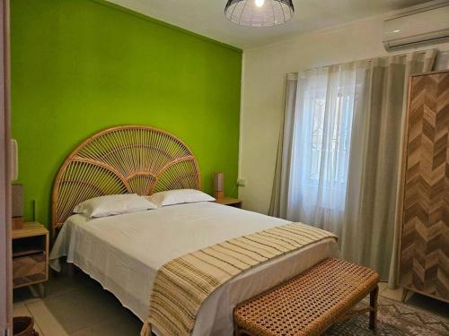 a bedroom with a large bed and a green wall at Villa Ti CoCo Elegant Tropical Villa with Pool and Terraces in Trou aux Biches