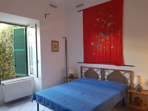 a bedroom with a blue bed and a window at Domus Neroniana - Ingresso privato alla spiaggia. in Anzio