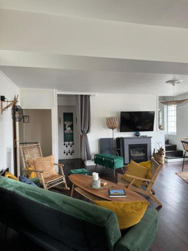 a living room with a couch and a table at VILLA LA PLAGE in Trouville-sur-Mer