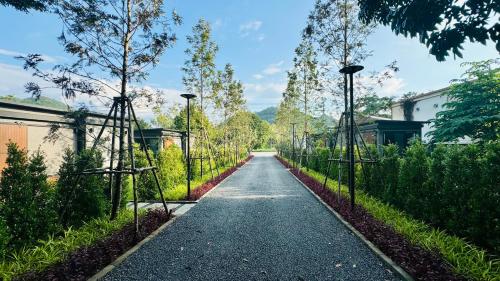 a road with a gate in the middle at Willow Tree House Khao Yai in Mu Si