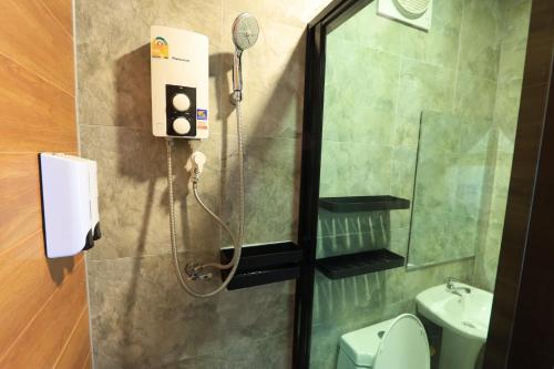 a bathroom with a shower with a toilet and a sink at Willow Tree House Khao Yai in Mu Si