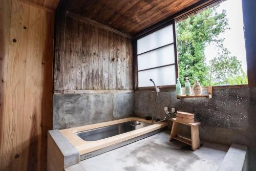 a kitchen with a sink and a large window at MAYUDAMAHOUSE in Higashiagatsuma