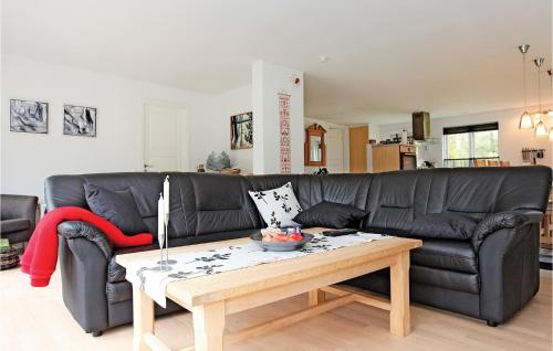 a living room with a black couch and a coffee table at Holiday Home Grevinge Xxvi in Grevinge