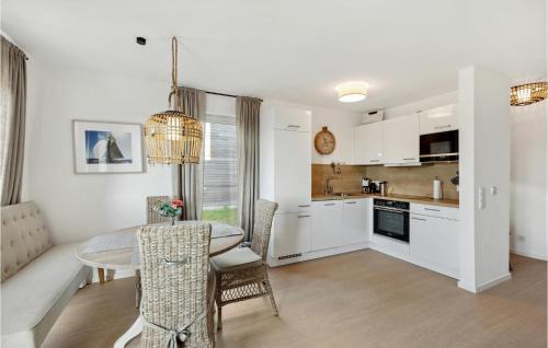 a kitchen and dining room with a table and chairs at Nice Home In Tossens With Sauna in Butjadingen OT Tossens