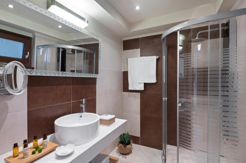 a bathroom with a sink and a shower at Alexandra Golden Boutique Hotel-Adults Only in Chrysi Ammoudia