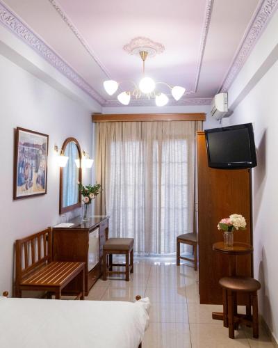 a living room with a couch and a television at Hotel Avra in Kardítsa