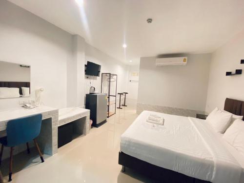 a hotel room with a bed and a sink at Makan Resort in Kanchanaburi