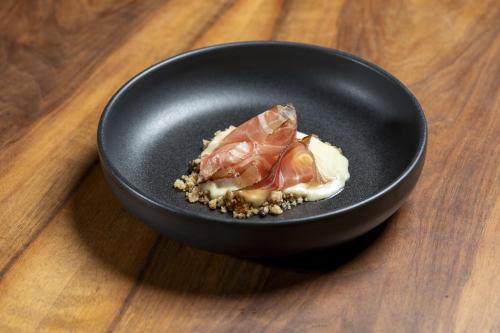 a black bowl with food in it on a table at Drei Könige in Entlebuch