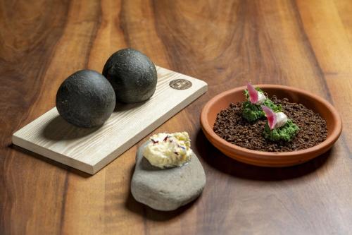 a wooden table with a bowl of food and a bowl of plants at Drei Könige in Entlebuch