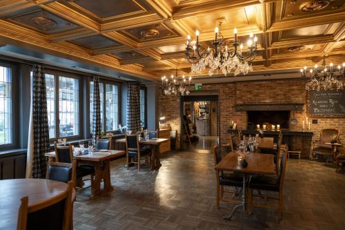 a restaurant with tables and chairs and a fireplace at Drei Könige in Entlebuch