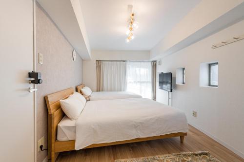 Ένα ή περισσότερα κρεβάτια σε δωμάτιο στο 東新宿1012