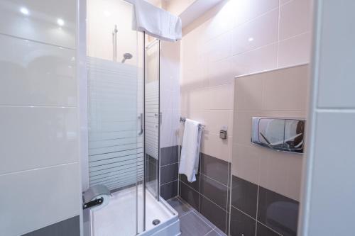 a bathroom with a shower with a glass door at Hotel Ski&Sky in Predeal