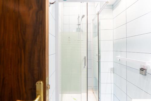 a shower with a glass door in a bathroom at Hotel Ski&Sky in Predeal