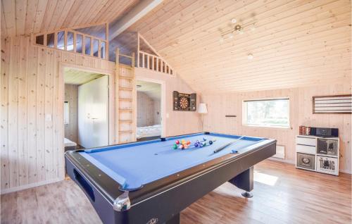 a pool table in a room with wooden walls at Holiday Home Vestensøvej Ebeltoft Iv in Ebeltoft