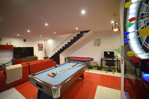 a living room with a pool table and a staircase at Villa Galiana By Florentia Homes in Toledo