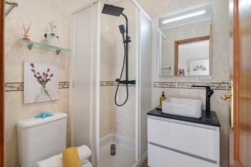 a bathroom with a shower and a toilet and a sink at Villa Martina in Albufeira