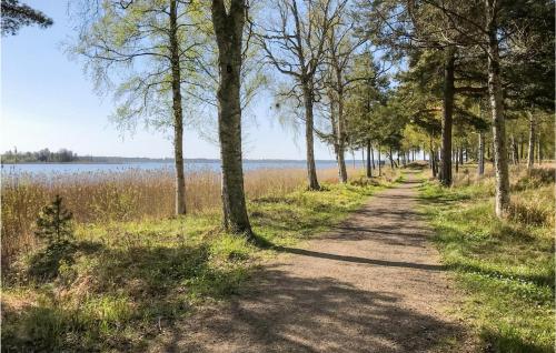 a dirt road with trees on either side at Amazing Home In Karlsborg With Wifi in Karlsborg