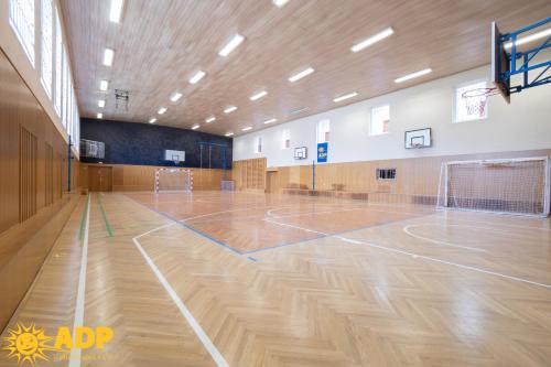 an empty gymnasium with a wooden basketball court at Areál dobré pohody in Žimrovice