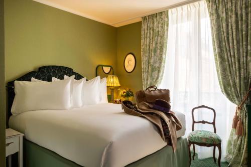 a hotel room with a bed and a window at UNE AUTRE CHAMBRE in Paris