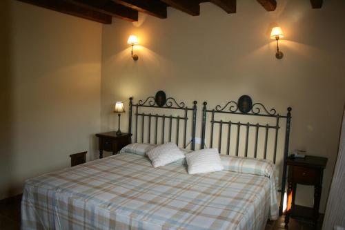 a bedroom with a bed with two pillows on it at Hotel Posada Molino del Cubo in San Esteban del Valle