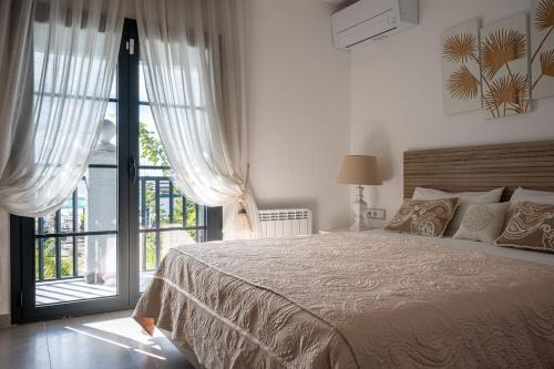 a bedroom with a large bed and a large window at AT153 First line of the beach in Creixell