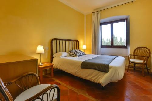 a hotel room with a bed and a window at MAS DE BERNIS - Senyoreta in L'Aldea