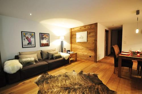 a living room with a couch and a table at Comfort apartment in Zermatt