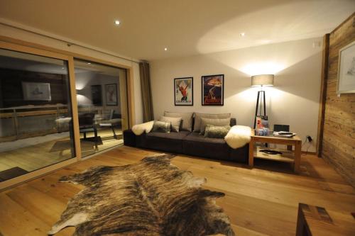 a living room with a couch and a table at Comfort apartment in Zermatt