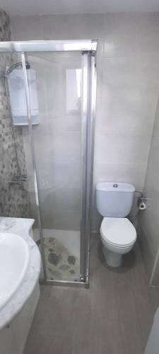 a bathroom with a shower and a toilet and a sink at Puerto del Carmen, Near Beach, Fast wifi, Pool in Puerto del Carmen
