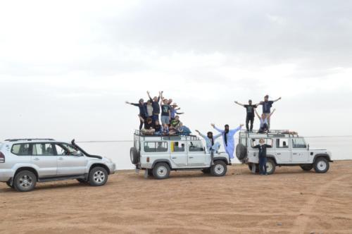 a group of people standing on top of their cars at Bivouac Les Nomades & Foum zguid to chegaga tours in Foum Zguid