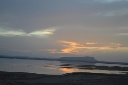 a sunset over a body of water with the sky at Bivouac Les Nomades & Foum zguid to chegaga tours in Foum Zguid