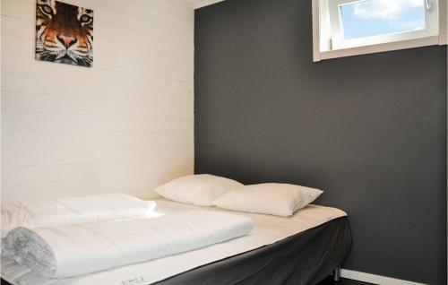 two pillows sitting on a bed in a room at Nice Home In Hammarö With Kitchen in Gunnarskär